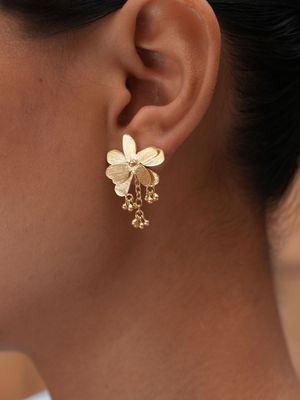 Product shot of small flower earrings by Belgian Christine Bekaert handcrafted statement jewelry on model