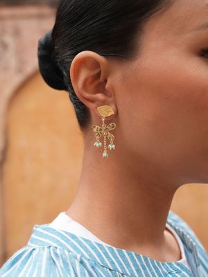 Product shot of small flower earrings with gold beads by Belgian Christine Bekaert handcrafted statement jewelry on model