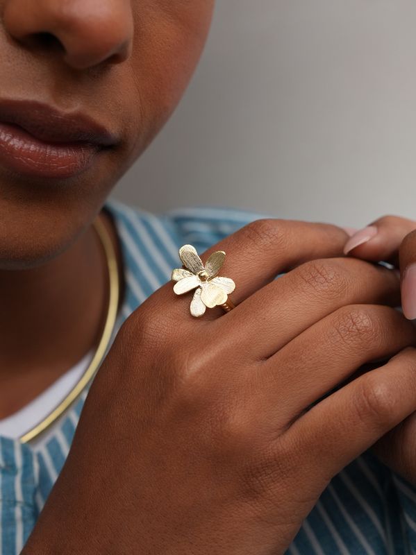 Product shot of adjustable flower ring by Belgian Christine Bekaert handcrafted statement jewelry on model