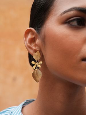 Product shot of medium flower earrings by Belgian Christine Bekaert handcrafted statement jewelry on model