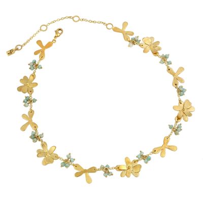 Product shot of flower necklace with gold beads by Belgian Christine Bekaert handcrafted statement jewelry