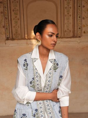 Product shot of large circular earrings by Belgian Christine Bekaert handcrafted statement jewelry on model