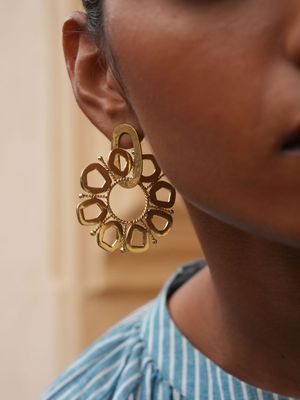 Product shot of large circular earrings by Belgian Christine Bekaert handcrafted statement jewelry on model