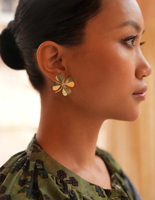 Product shot of large clover earrings by Belgian Christine Bekaert handcrafted statement jewelry on model