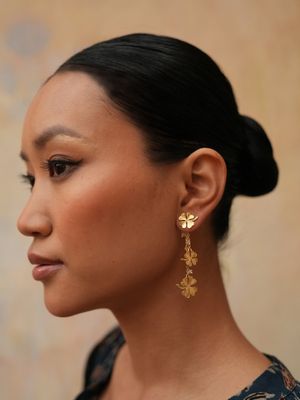Product shot of small clover earrings with white moonstone by Belgian Christine Bekaert handcrafted statement jewelry model