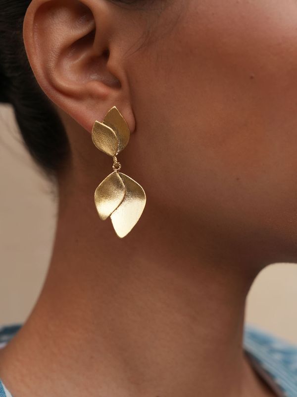 Product shot of medium flower earrings by Belgian Christine Bekaert handcrafted statement jewelry on model