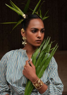 Product shot of large flower earrings with white moonstone by Belgian Christine Bekaert handcrafted statement jewelry model