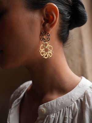 Product shot of small circular earrings by Belgian Christine Bekaert handcrafted statement jewelry on model