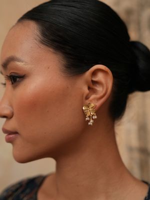 Product shot of small clover earrings with pearls by Belgian Christine Bekaert handcrafted statement jewelry on model