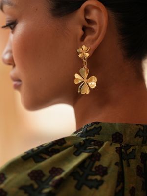 Product shot of medium clover earrings by Belgian Christine Bekaert handcrafted statement jewelry on model