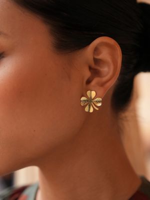 Product shot of small clover earrings by Belgian Christine Bekaert handcrafted statement jewelry on model
