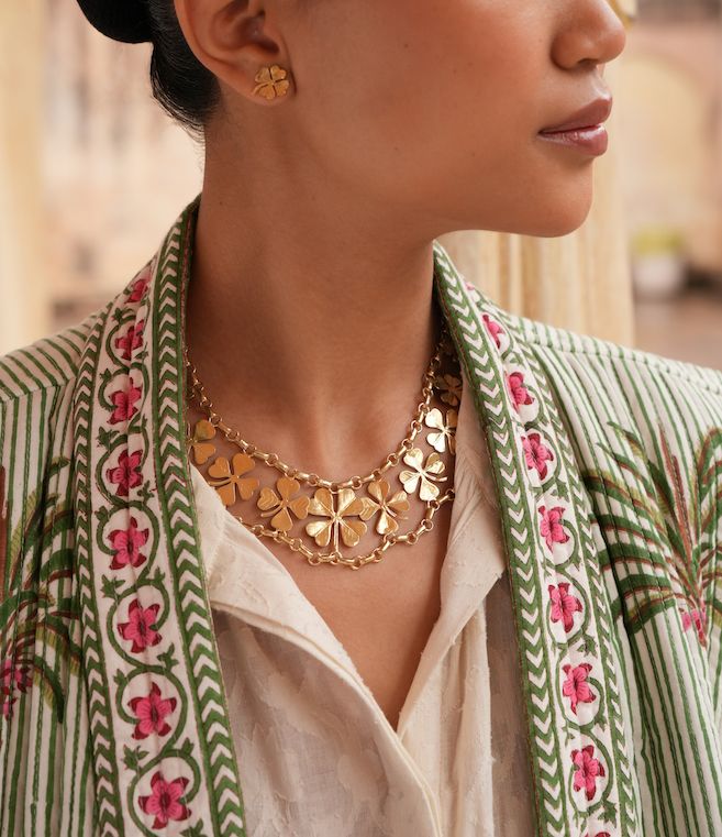 Product shot of short clover necklace by Belgian Christine Bekaert handcrafted statement jewelry on model