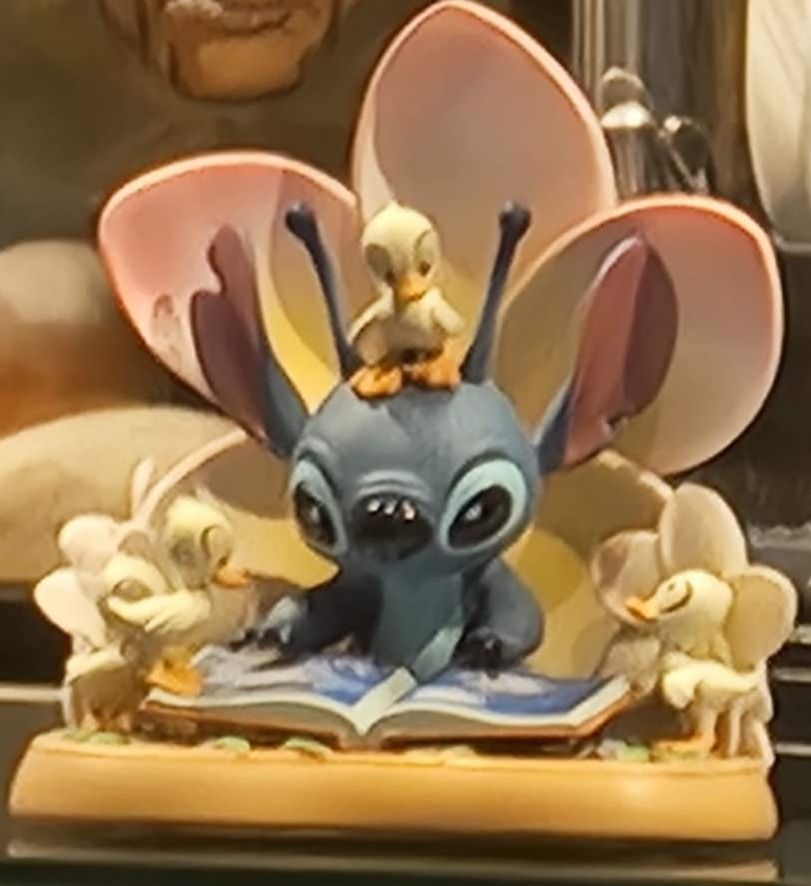 Stitch reading to Ducklings figure