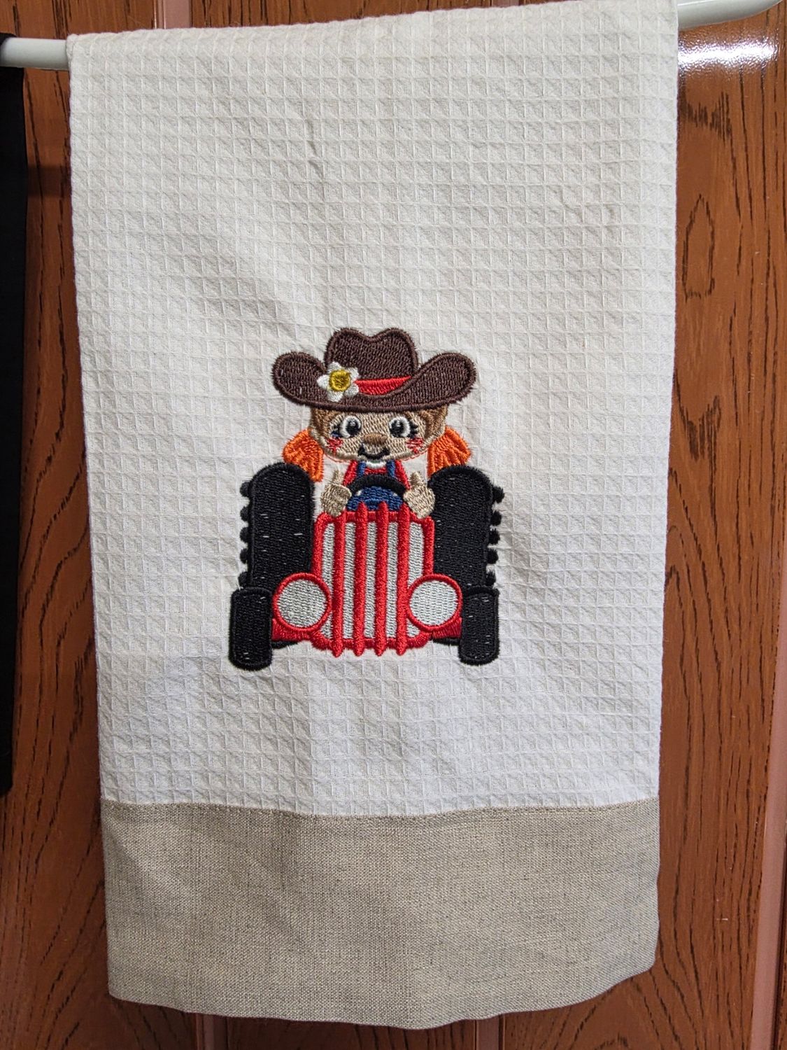 Linen Guest towel with a Girl on a Tractor Embroidered on it