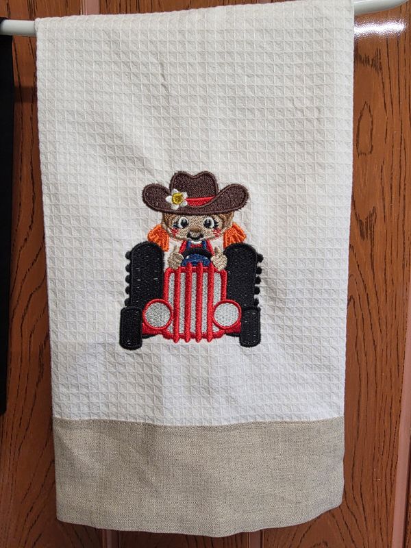 Linen Guest towel with a Girl on a Tractor Embroidered on it