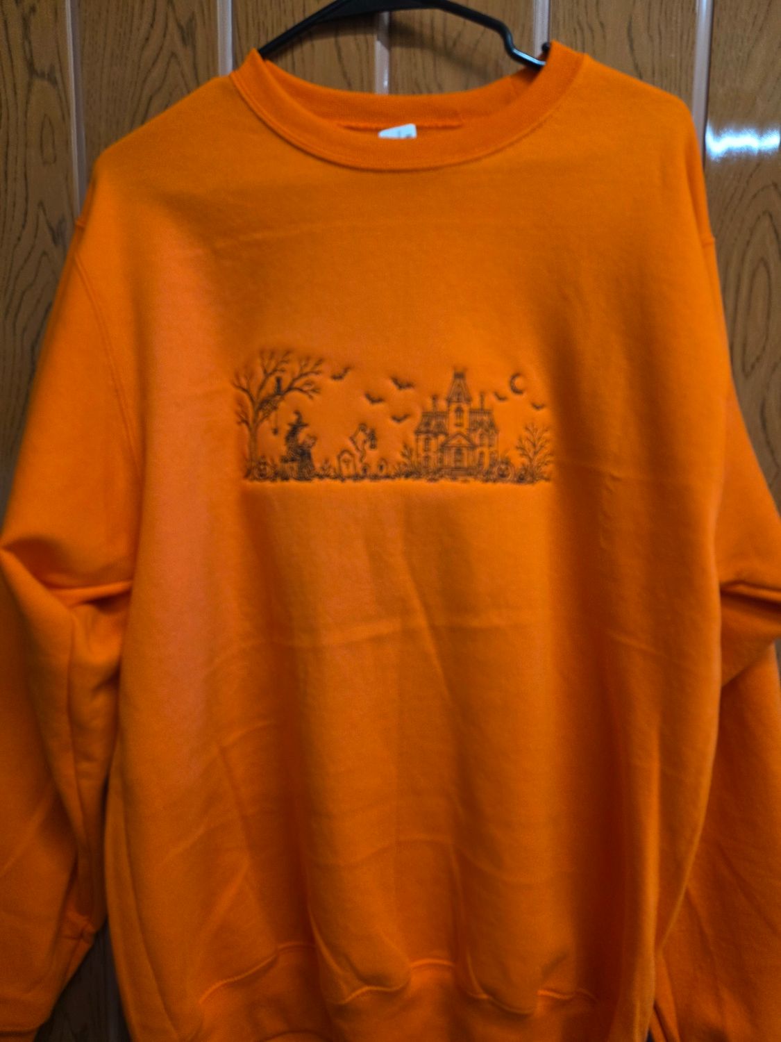 Core Fleece Crewneck Sweatshirt with a Haunted scene Embroidered on it