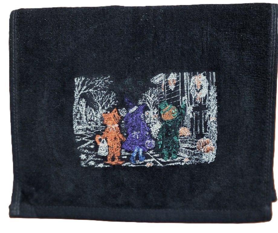 Hemmed Hand Towel with a Embroidered Trick or Treat Scene
