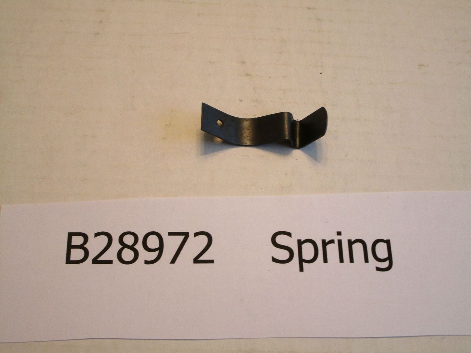 John Deere Planter Part # B28972 Spring for Hopper floor plate, with pop rivet.