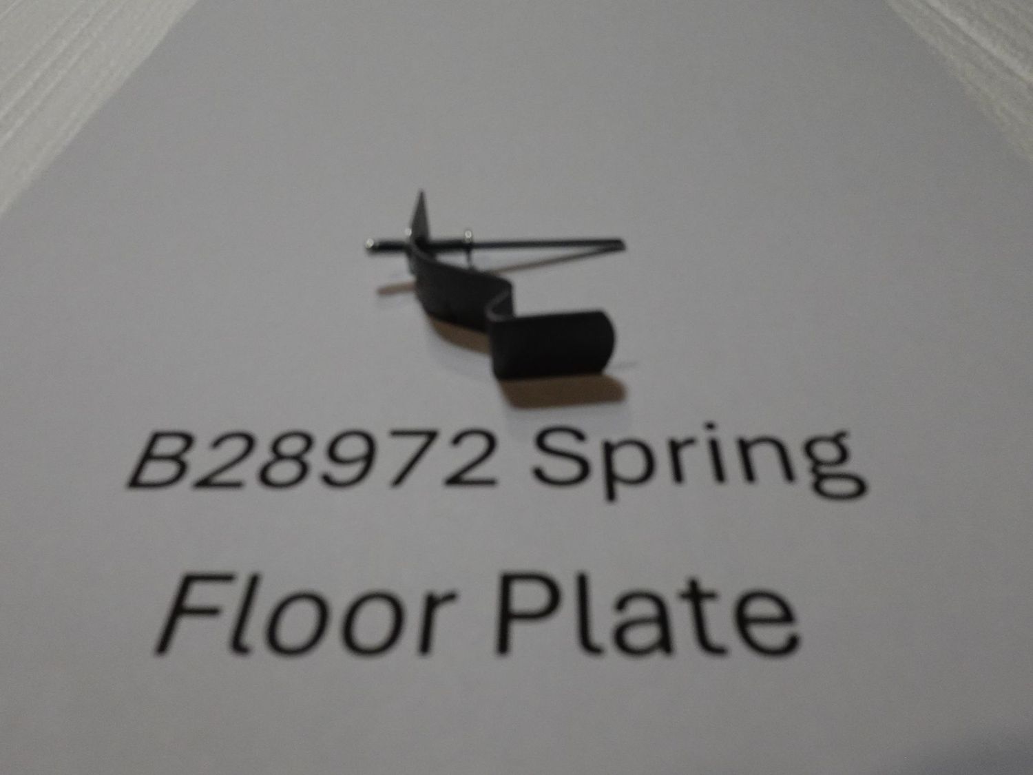 John Deere Planter Part # B28972 Spring for Hopper floor plate, with pop rivet. John Deere Planter Part # B28972 Spring for Hopper floor plate, with pop rivet.