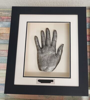 ONE ADULT HAND IN THE FRAME