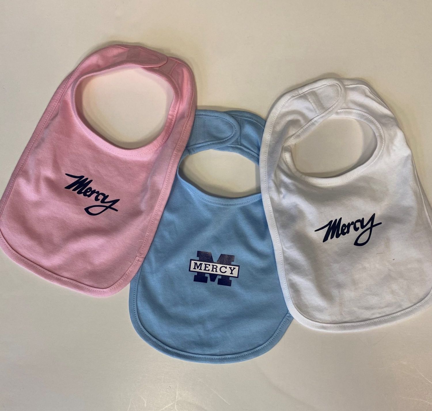 Mercy Bib, color: White script