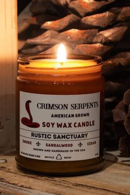 The scent profile features notes of smoke, sandalwood, and cedar.