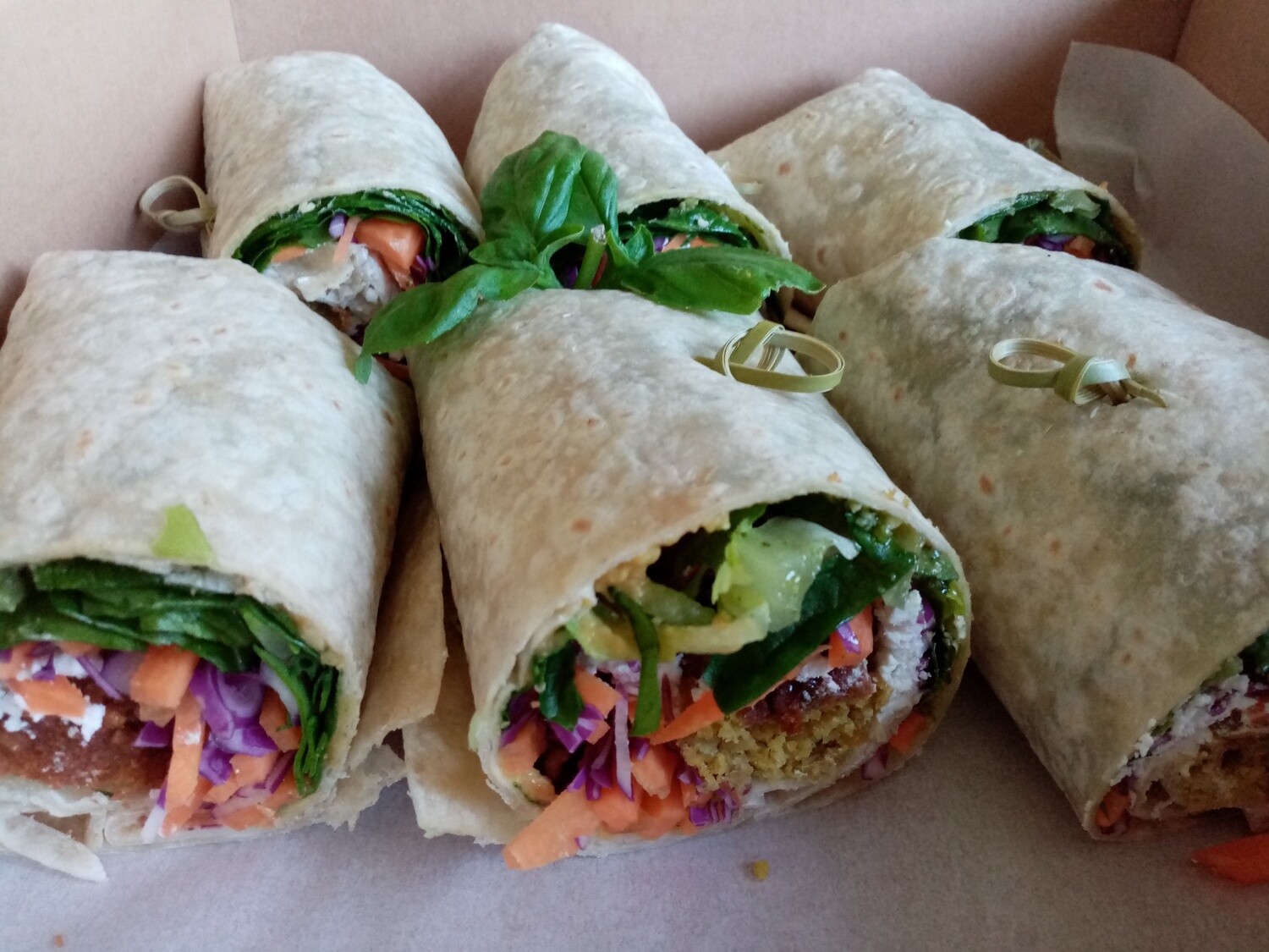 10x HALF WRAPS. Half wholemeal wraps filled with greens, carrot, red cabbage, feta, seasonal Hummus and wholegrain mustard. Your choice Falafel or Chicken.