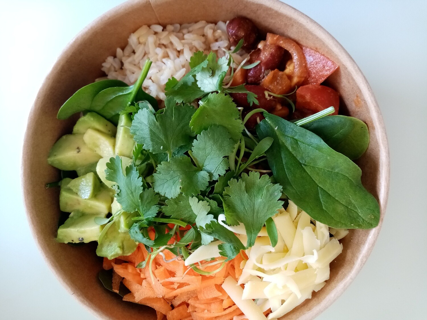 BURRITO BOWL OR WRAP. rice salad with kidney beans, corn, red onion, capsicum, tomato, avo, coriander, crated carrot, edam cheese, baby spinach with mild spices, sour cream and lime juice. GF