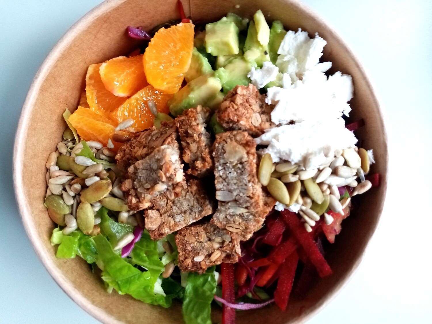 WELLNESS BOWL. toasted buckwheat and seed bread croutons, cos lettuce, grated carrot, beetroot, celery, orange and avocado, toasted seeds. Your choice vinaigrette and extras.