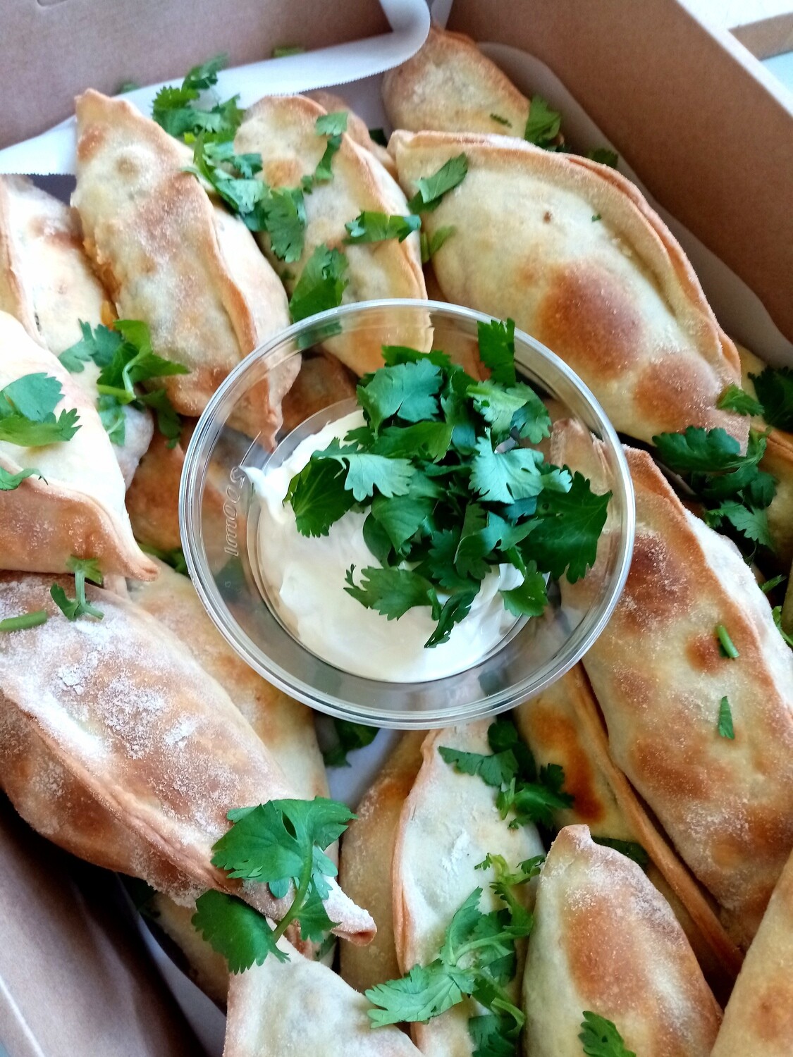 20x snack empanadas with beef or vegetarian filling, sour cream and coriander.