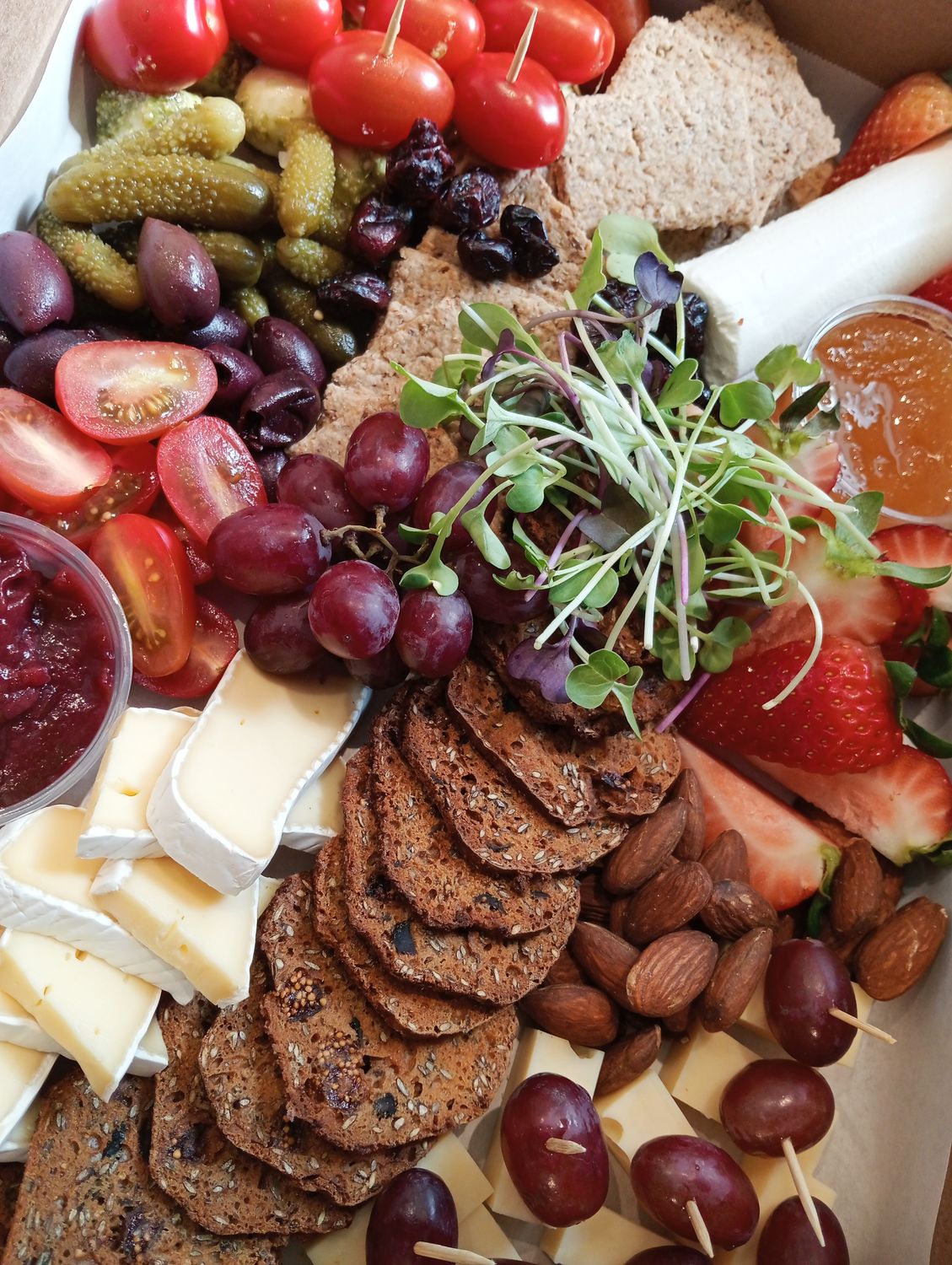 CHEESE PLATTER FOR 6. Tomato-mozarella skewers. Pesto. Swiss cheese-grape skewers. Goats cheese and raw honey. Camembert. Chutney. Kalamata olives. Gherkins. Nuts. cranberries. Crackers.GF available.