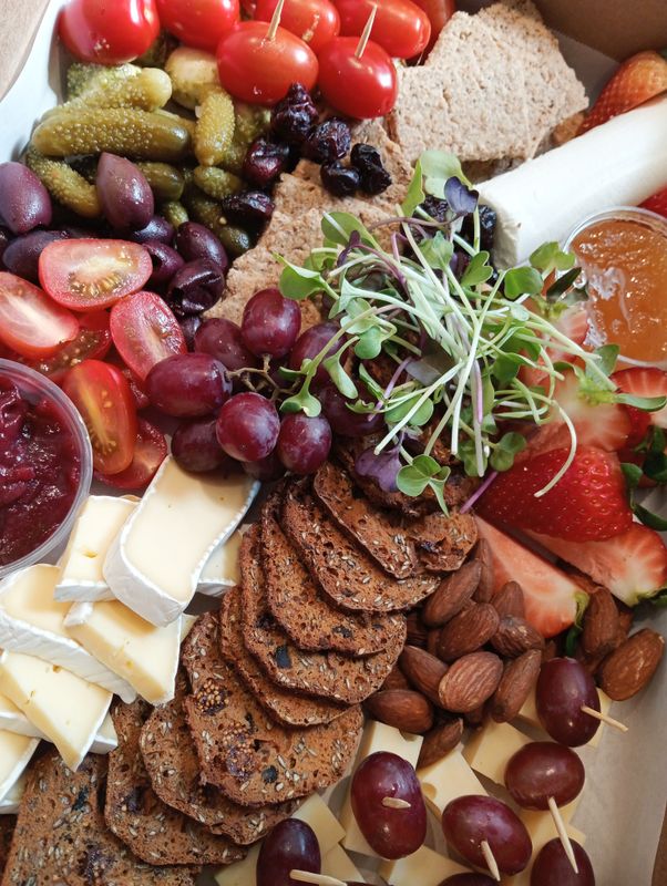 CHEESE PLATTER FOR 6. Tomato-mozarella skewers. Pesto. Swiss cheese-grape skewers. Goats cheese and raw honey. Camembert. Chutney. Kalamata olives. Gherkins. Nuts. cranberries. Crackers.GF available.