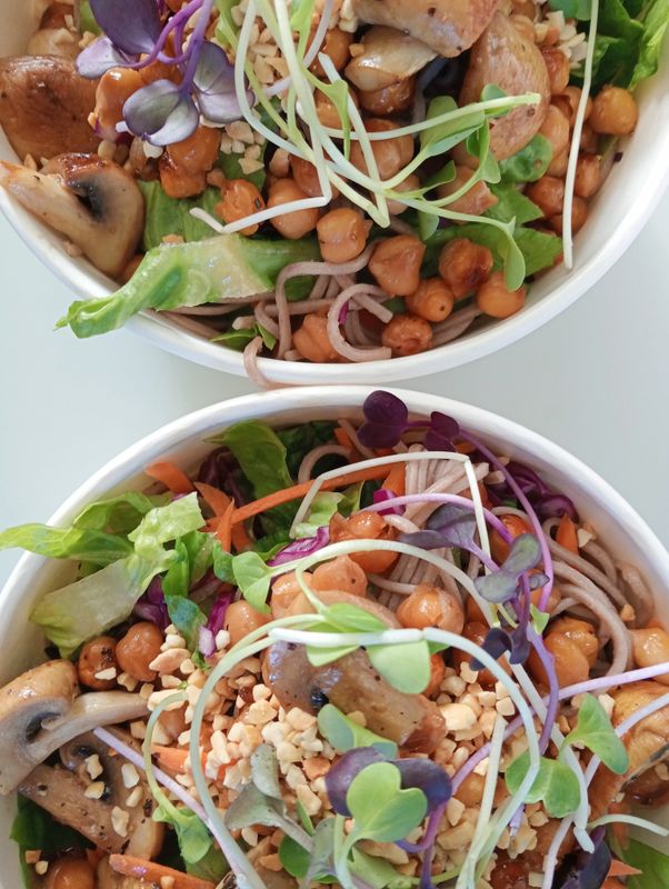 NOODLE BOWL Soba noodle salad with asian style slaw, coriander, sesame seeds, springonions, roasted edamame beans, and panfried tofu. Dressed with soy sauce, sesame oil and apple cider vinegar.