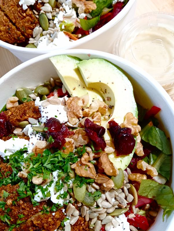 RAINBOW FALAFEL SALAD Colorful raw salad with homemade falafel, feta, cos lettuce, toasted seeds, walnuts, dried cranberries and apple cider - lemon - honey - mustard vinaigrette.