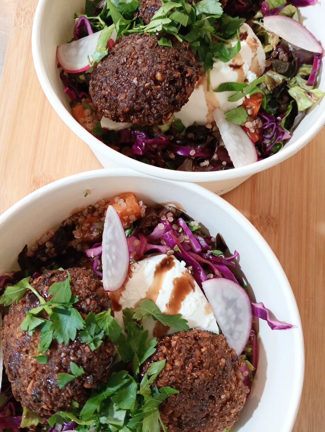 FALAFEL BOWL Homemade Falafel on a honey roasted vegetable salad with greens, red cabbage, red onion, cucumber, parsley, feta, avocado and balsamic vinnaigrette.