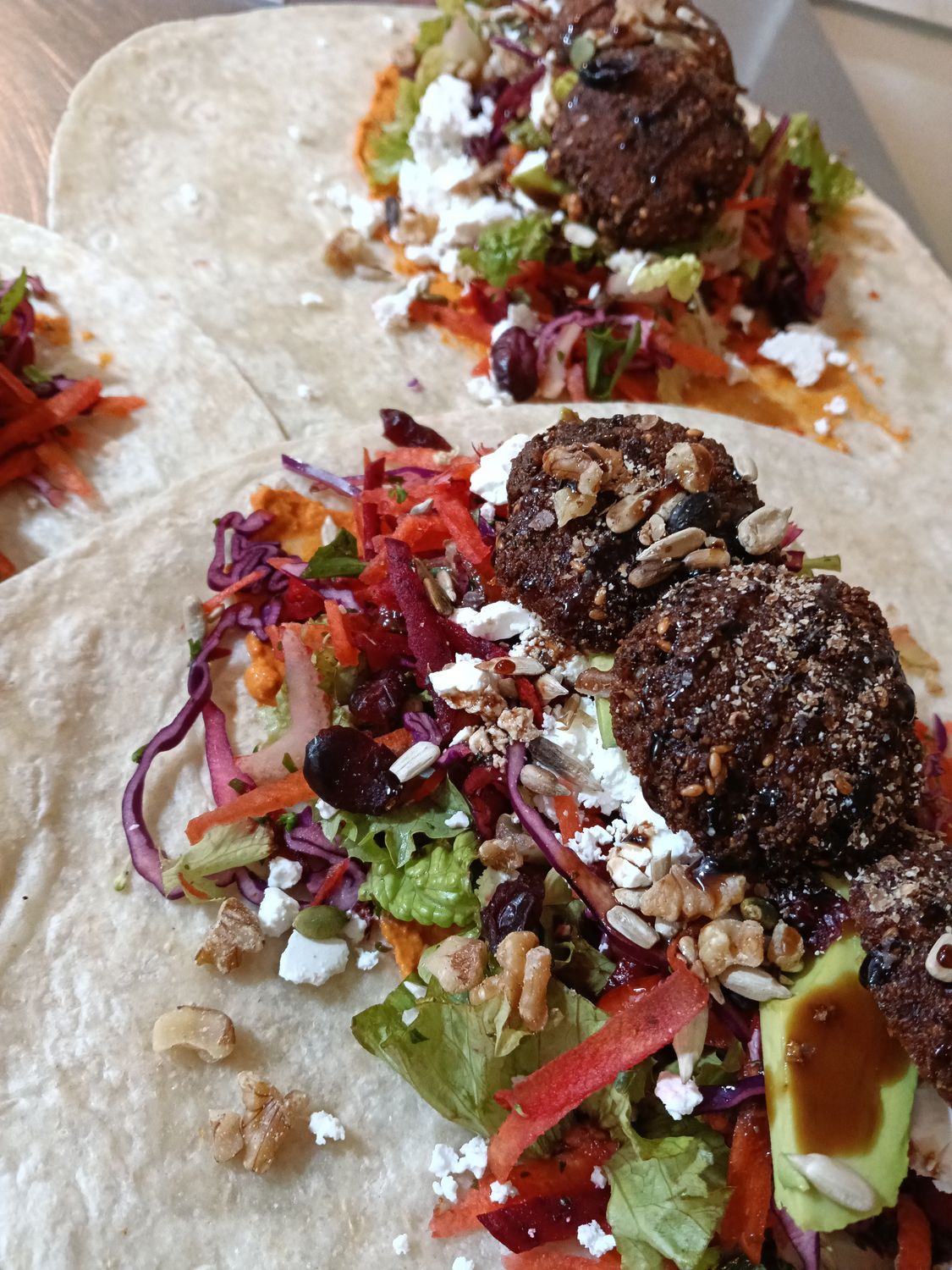 FALAFEL WRAP large tortilla with rainbow salad, falafel,feta,balsamic, cranberries, seeds,hummus,avocado