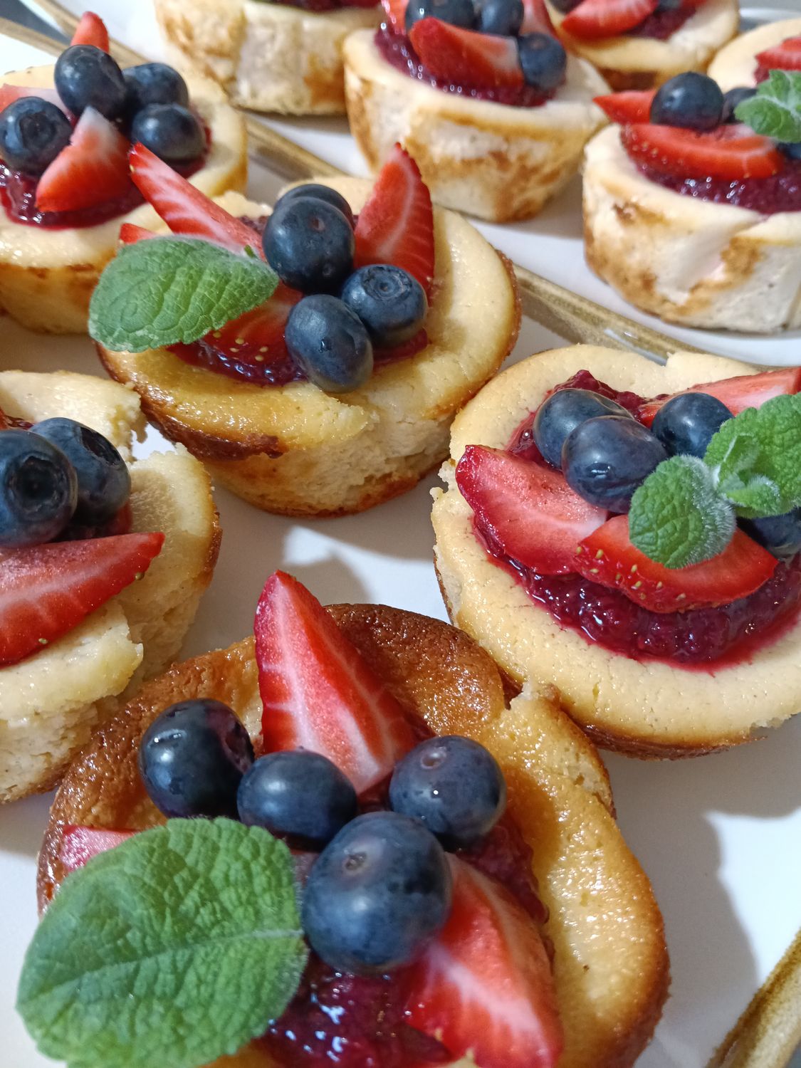 10x RICOTTA CHEESECAKE. Baked cheesecakes topped with raspberry chia jam and fresh berries