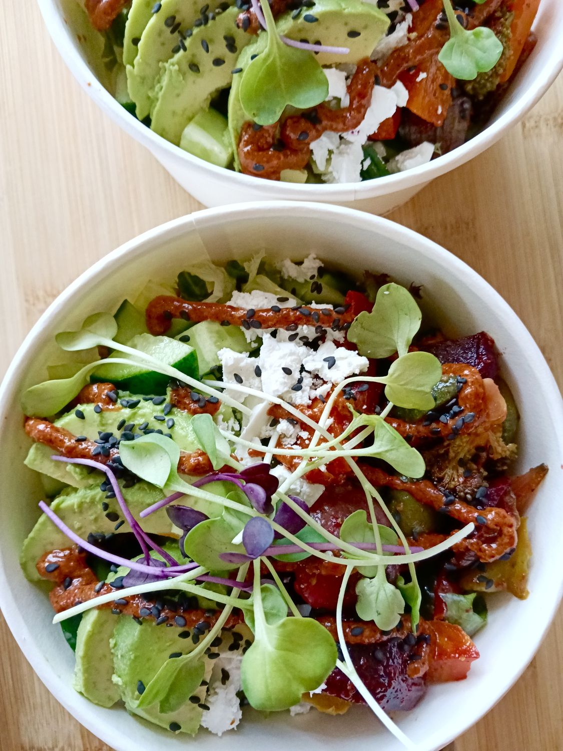 ROASTY BOWL. Honey moroccan roasted root and seasonal vegetables with salad greens, cucumber, feta, avocado, black sesame seeds, muhammara, balsamic vinaigrette or yoghurt sauce  GF