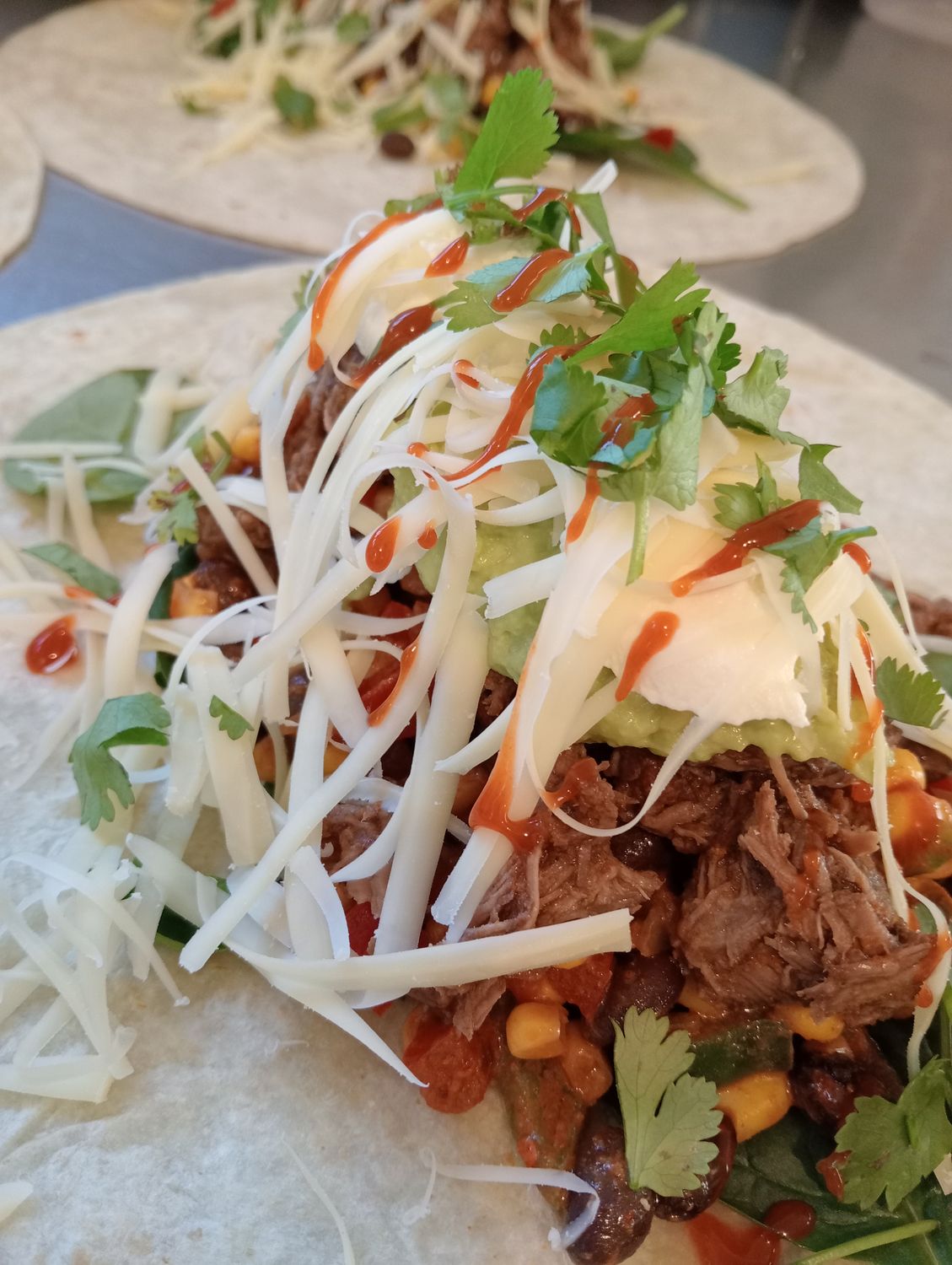 BEEF BURRITO. Tortilla filled with black bean salsa, avocado, sour cream, grated edam, spinach and slow cooked beef. Suitable for toasting in the sandwich press.