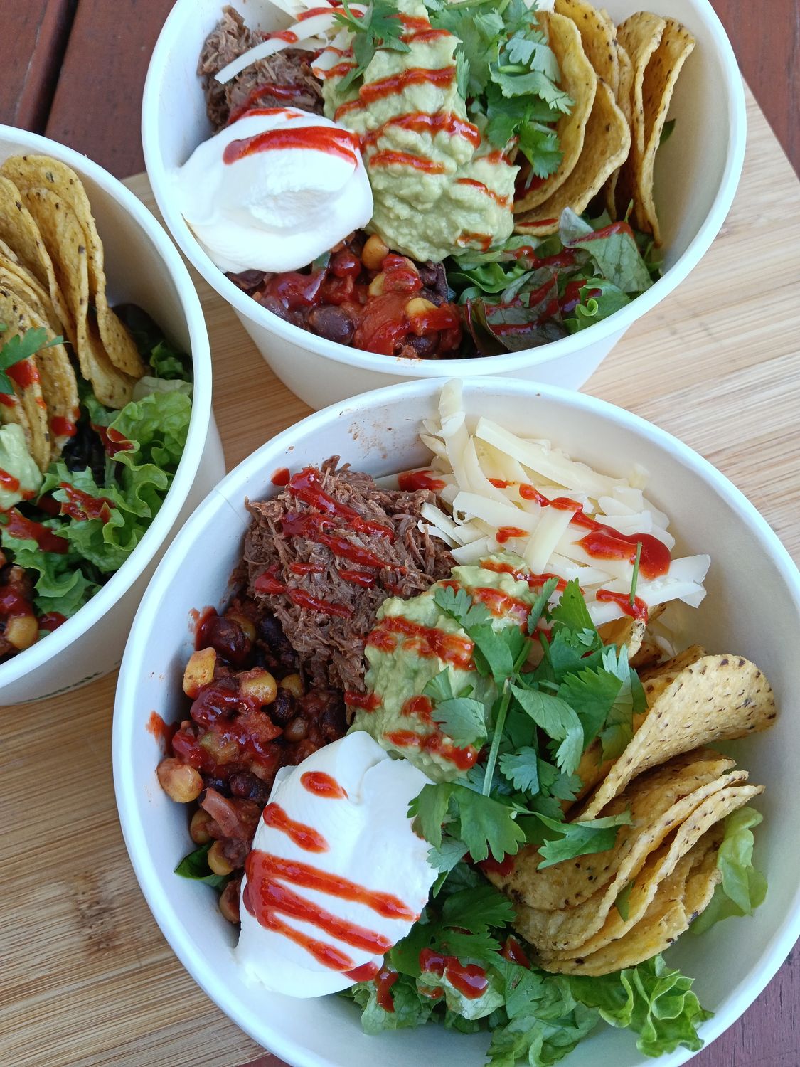 BURRITO BOWL Basmati rice with salad greens, spiced black bean salsa (corn, capsicum, tomato, red onion, beans) grated edam, sour cream, guacamole, coriander, sriracha sauce.  GF (cold dish)