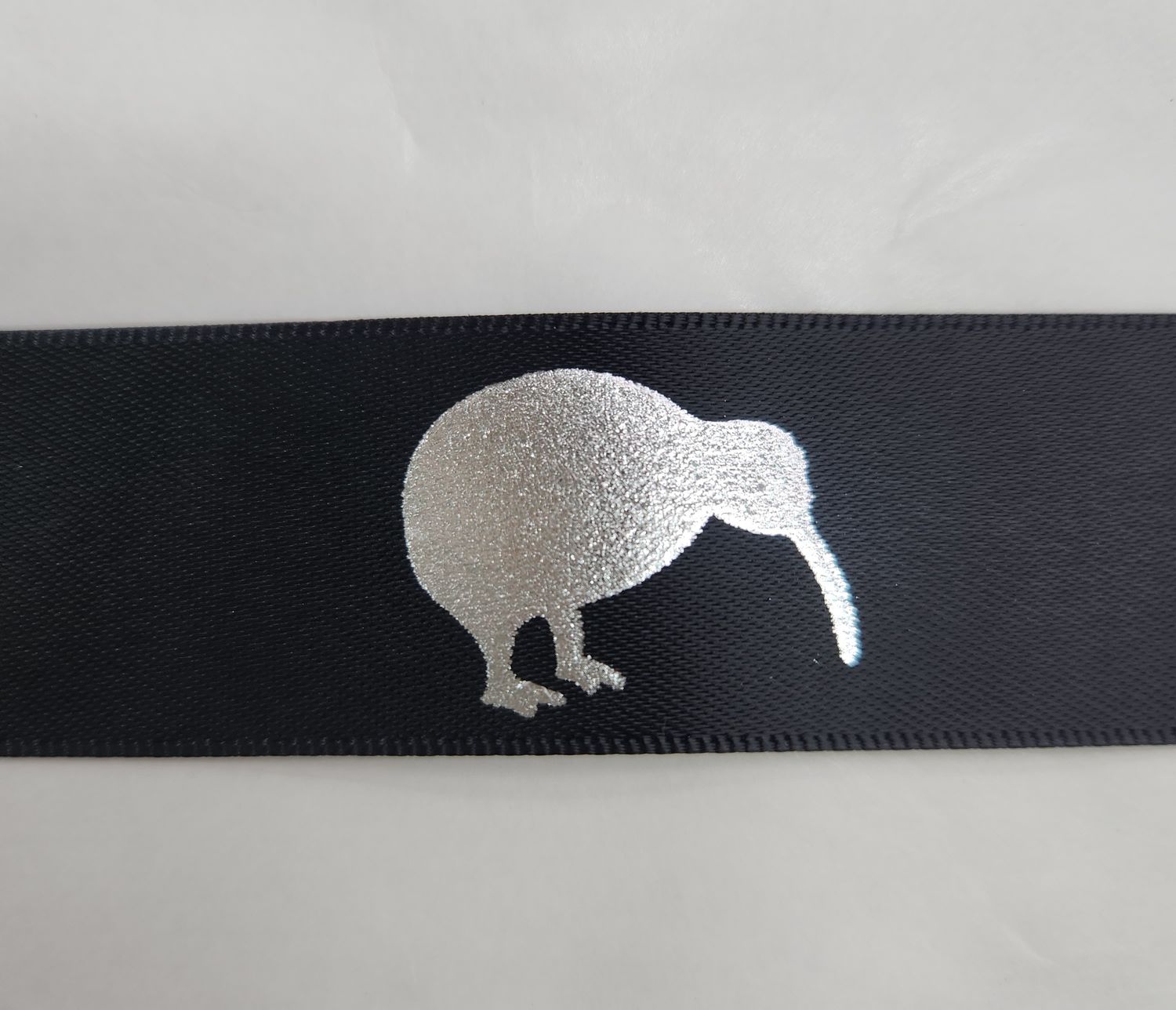Metallic Silver Kiwis on Black Ribbon 25mm Width, Price per metre
