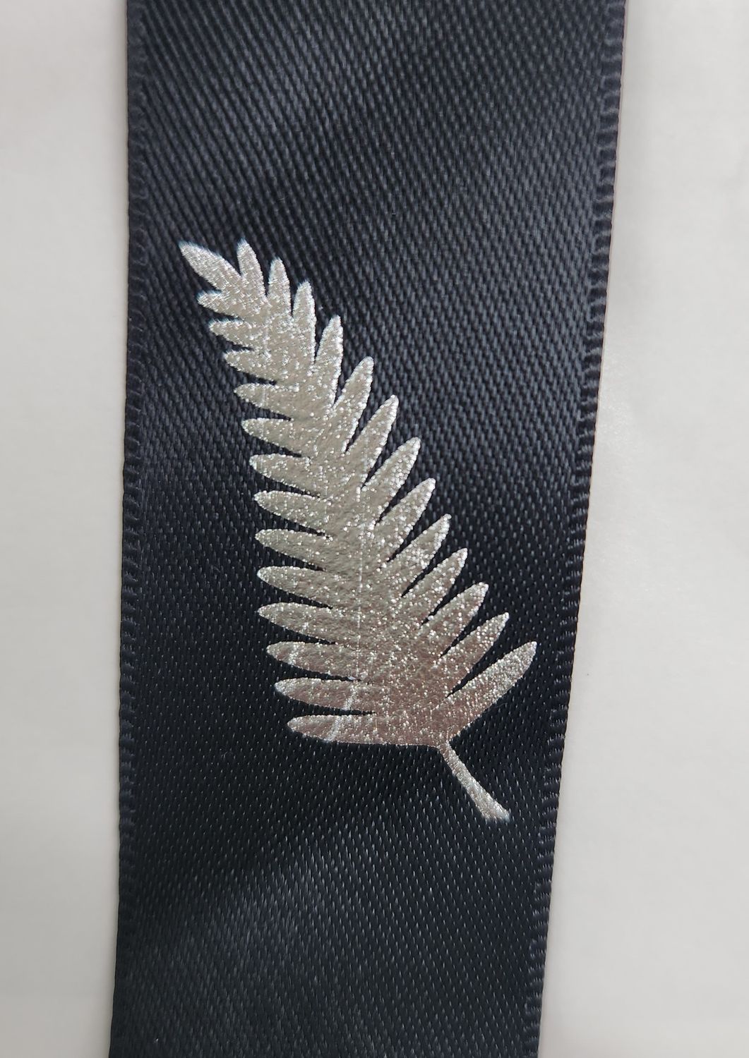 Metallic Silver Ferns on Black Ribbon 25mm Width, Price per metre