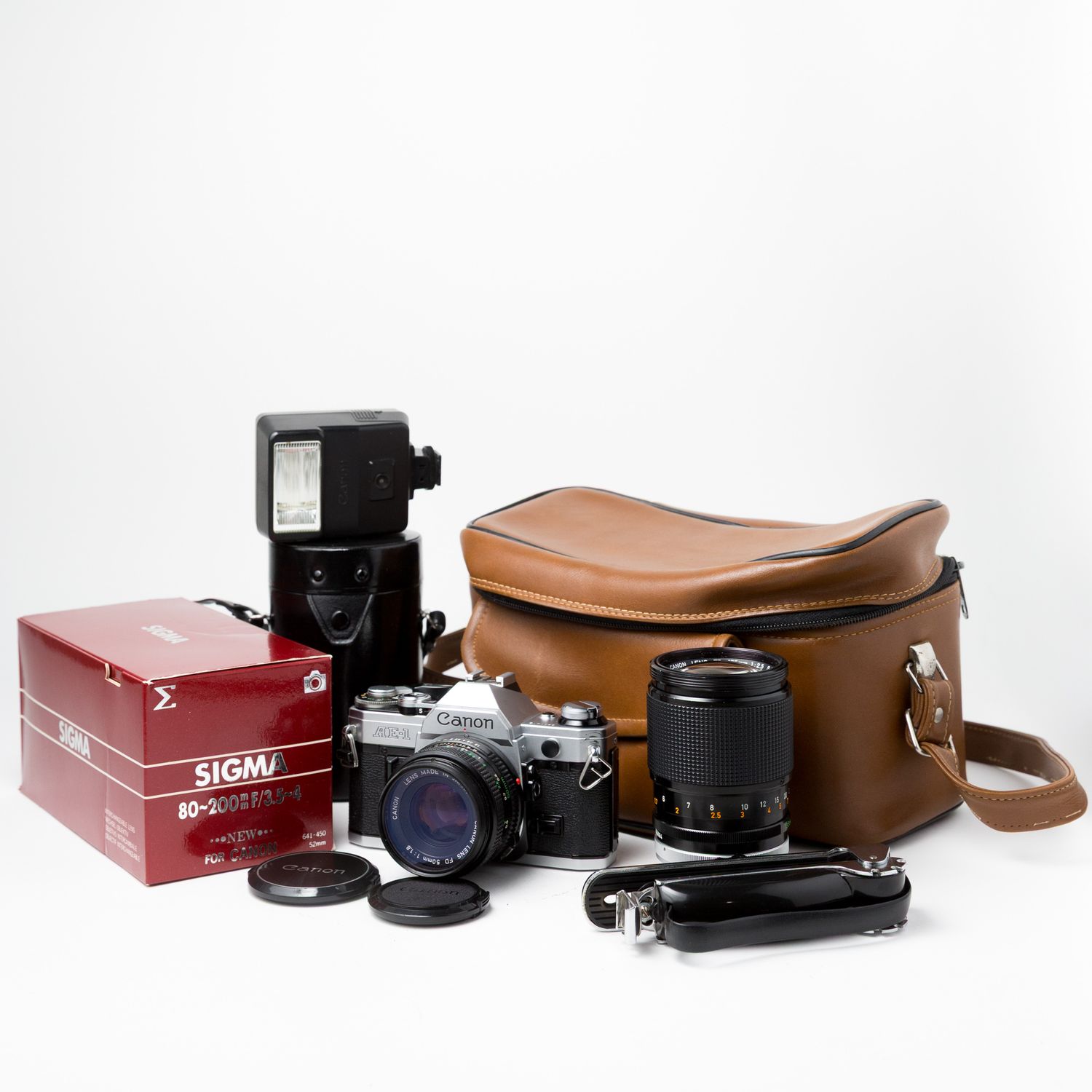 Canon AE-1 w/ 50mm, 135mm, 80-200mm lenses, carry bag, grip, and flash