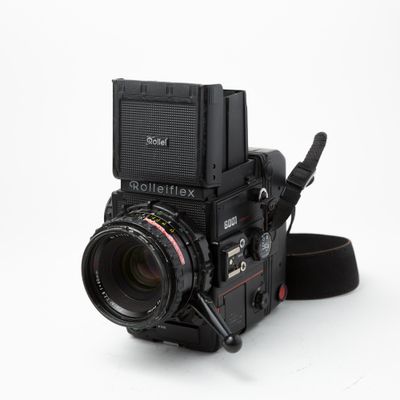 Rollei 6001 w/80mm f/2.8, 50mm f/4 lenses, spare battery, spare magazine, and pistol grip