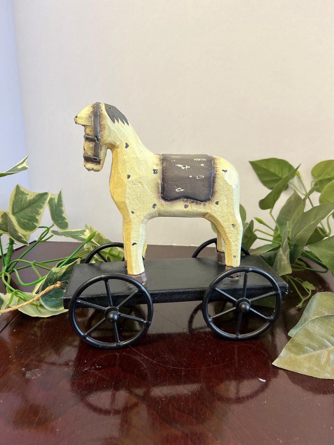 Off White Wooden Speckled Horse on a Platform with Metal Wheels