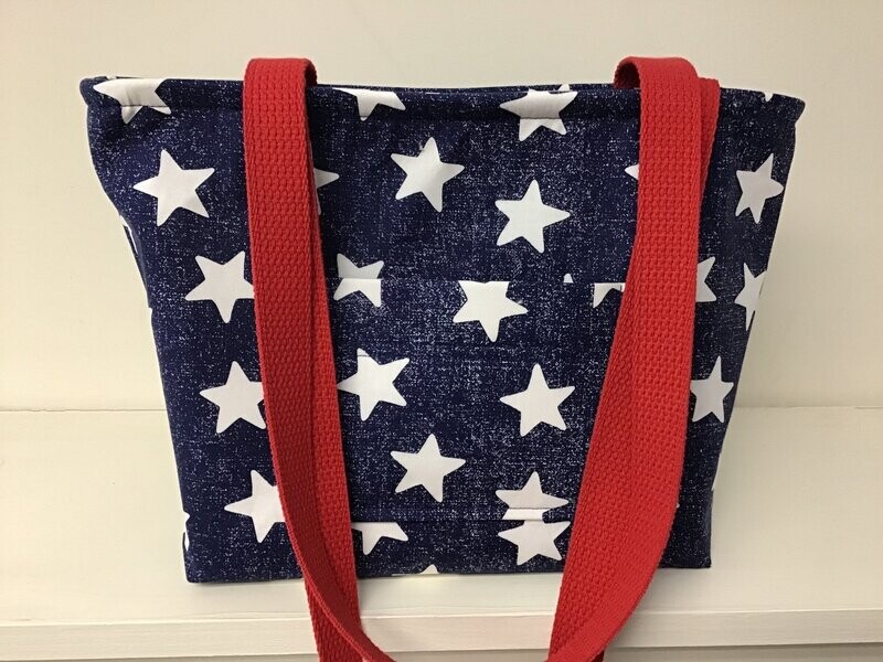 The look of faded denim in this blue star print, red accents and straps