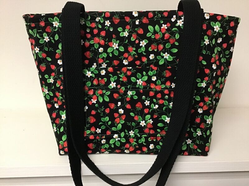 Tiny strawberries with leaves and flowers on black, black straps