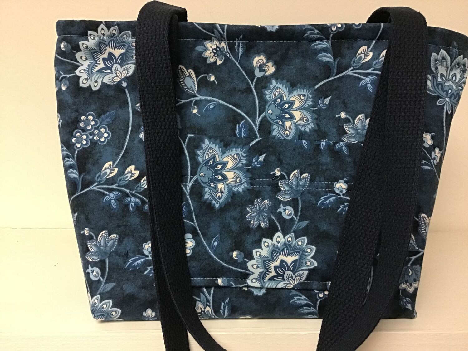 Light blue exotic floral print on dark blue, dark blue straps