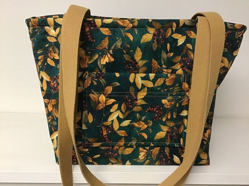 Sunlit leaves and berries on green, raffia straps