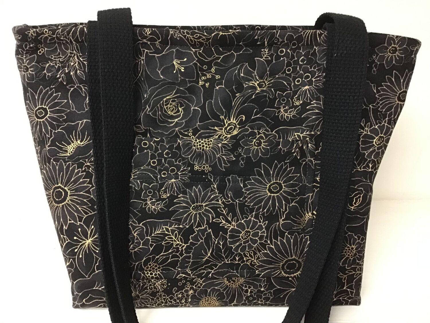 Steel gray flowers outlined in gold on black, black straps